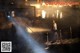 A man standing on a dock at night with a flashlight.