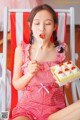 A woman sitting in a chair eating a piece of cake.