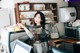 A woman sitting at a counter in a coffee shop.