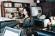 A woman sitting at a counter in a coffee shop.