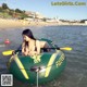 A woman sitting in an inflatable boat in the water.