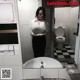 A woman taking a selfie in a bathroom mirror.