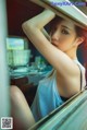 A woman sitting in a car looking out the window.