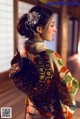 A woman in a kimono with a flower in her hair.