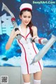 A woman dressed as a nurse holding a sword.