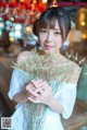 A woman holding a bunch of flowers in her hands.