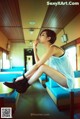 A woman sitting on a table in a diner.