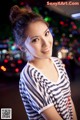 A woman in a striped shirt posing for a picture.