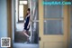 A woman in a blue dress standing in an abandoned building.