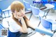 A young woman sitting at a desk in a classroom.