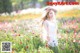 A woman standing in a field of flowers.