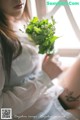 A woman holding a bouquet of flowers in her hand.