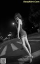 A woman in a short dress is walking down the street.