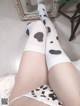 a woman wearing white socks with black spots on them