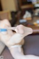 A close up of a person holding a toothbrush in their hand.