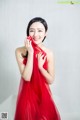 A woman in a red dress posing for a picture.