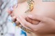 A close up of a person holding a butterfly on their stomach.