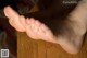 A close up of a person's bare feet on a table.