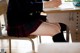 A woman sitting at a desk writing in a notebook.