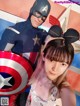 A man and a woman dressed up as Captain America and Minnie Mouse.