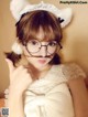 A woman wearing glasses and a cat ears headband.