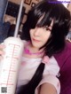 A woman with long black hair holding a measuring cup.