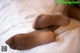 A close up of a person's feet on a bed.