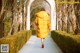 A woman in a yellow coat walking down a sidewalk.