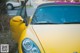 A yellow sports car parked on the side of the road.