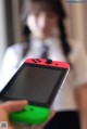 A person holding a red and green Nintendo Switch.