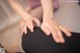 A close up of a person's hands on a chair.