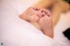 A close up of a baby's feet on a bed.