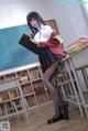 A woman in a school uniform holding a clipboard.