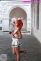 A woman in a sailor outfit is posing for a picture.