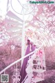 A woman in a purple dress standing on a spiral staircase.