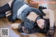 A woman laying on the floor in a black and white dress.