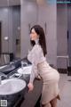 A woman standing in front of a bathroom sink.