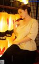 a woman sitting on a chair in front of a bunch of lanterns