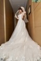 A woman in a wedding dress standing in a hallway.