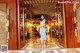 A woman standing in the lobby of a hotel.