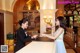 A woman in a blue dress standing at a reception desk.