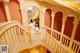 A woman in a white dress is standing on a staircase.