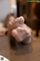 A woman's bare feet on a table. 